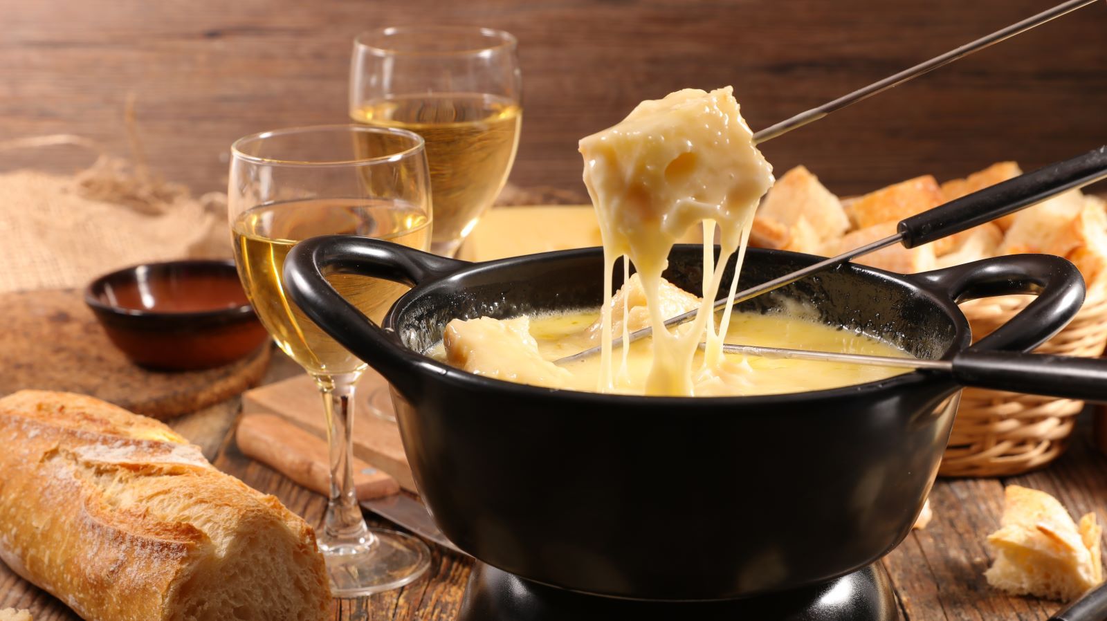 bread dipped into cheese fondue pot